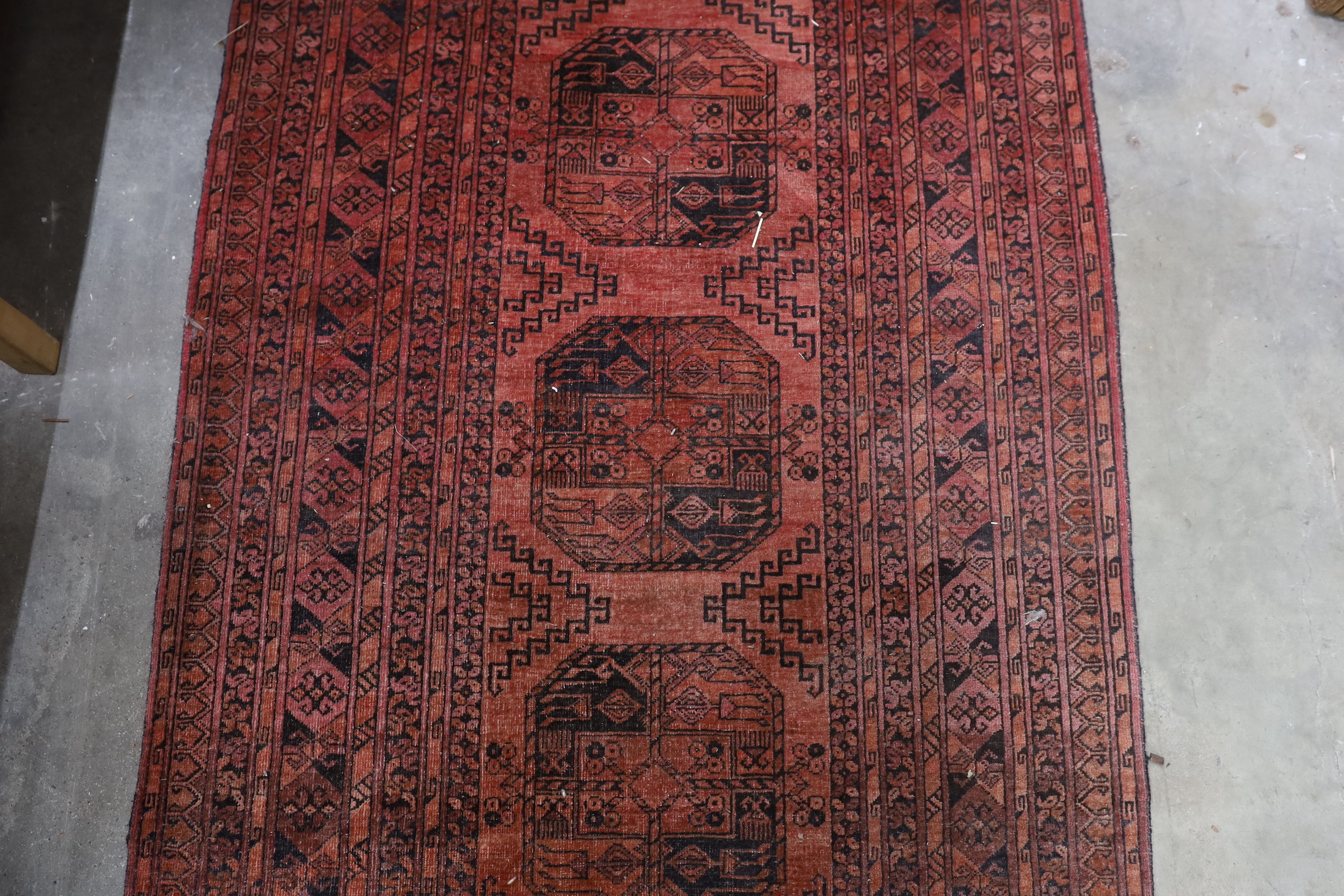 An antique Tekke rug 138cm x 66cm and an Afghan runner 280cm x 104cm.